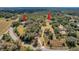 Aerial view of estate, lush acreage, mature trees, main house and separate guest house at 9210 County Road 48, Yalaha, FL 34797