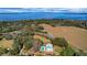 Aerial view of waterfront property with home, pool, and expansive land at 9210 County Road 48, Yalaha, FL 34797