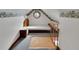 Finished attic with a bed, unique stained glass window, and eaves storage space, providing a functional and charming retreat at 9210 County Road 48, Yalaha, FL 34797