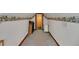 Attic space with vintage wallpaper border, neutral carpet, and a doorway, offering a unique and versatile area at 9210 County Road 48, Yalaha, FL 34797