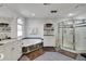 Elegant bathroom with soaking tub and a glass-enclosed shower at 9210 County Road 48, Yalaha, FL 34797