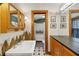 Bathroom featuring a white sink, mosaic-style decor, and a separate toilet area at 9210 County Road 48, Yalaha, FL 34797