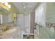 Bright bathroom with nature themed wallpaper, and shower, offering a relaxing and functional space at 9210 County Road 48, Yalaha, FL 34797