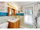 Bathroom featuring bright sea-themed wallpaper, vanity with storage, and a window for natural light at 9210 County Road 48, Yalaha, FL 34797