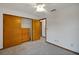 Bedroom with double door closet and ceiling fan at 9210 County Road 48, Yalaha, FL 34797