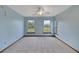 Light blue bedroom with two windows and ceiling fan at 9210 County Road 48, Yalaha, FL 34797