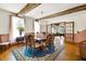 Formal dining room with exposed beams and chandelier at 9210 County Road 48, Yalaha, FL 34797