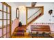Inviting entryway features a staircase, bench, decorative accents, and hardwood floors, offering a warm welcome at 9210 County Road 48, Yalaha, FL 34797
