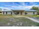 Brick ranch home with metal roof and covered porch at 9210 County Road 48, Yalaha, FL 34797