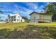 Charming two-story home with a well-maintained lawn and an inviting guest house on a sunny day at 9210 County Road 48, Yalaha, FL 34797