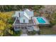 Charming two-story home with a wrap-around porch and an inviting in-ground pool at 9210 County Road 48, Yalaha, FL 34797