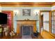 Brick fireplace with wooden mantel in a light-colored room at 9210 County Road 48, Yalaha, FL 34797