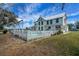 Two-story house with a white picket fence surrounding the pool at 9210 County Road 48, Yalaha, FL 34797