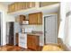 Bright kitchen with stainless steel appliances, wooden cabinets, and a unique loft area, combining functionality and charm at 9210 County Road 48, Yalaha, FL 34797