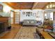 Inviting living room featuring a fireplace, comfortable seating, and hardwood floors at 9210 County Road 48, Yalaha, FL 34797