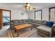 Living room featuring a wooden coffee table, a large sectional couch and a window at 9210 County Road 48, Yalaha, FL 34797