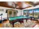 Game room with a pool table and natural light from windows at 9210 County Road 48, Yalaha, FL 34797