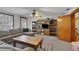 Spacious living room with a ceiling fan, large windows, and built-in bookcase, perfect for relaxing and entertaining at 9210 County Road 48, Yalaha, FL 34797