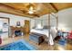 Main bedroom with wooden four-poster bed and fireplace at 9210 County Road 48, Yalaha, FL 34797