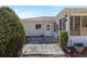 A backyard area with a covered patio and a white door entrance and a tiled walkway at 9951 Se 175Th St, Summerfield, FL 34491