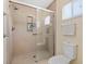 Bright bathroom showcasing a tiled shower with glass door and built in storage niche at 9951 Se 175Th St, Summerfield, FL 34491