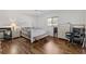 Inviting bedroom featuring wood floors, neutral walls, and a serene atmosphere at 9951 Se 175Th St, Summerfield, FL 34491