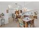 Bright dining area featuring a chandelier, tiled floors, and rattan furniture at 9951 Se 175Th St, Summerfield, FL 34491