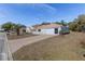 A well-maintained single-story home featuring a neatly landscaped lawn and a two-car garage, enhanced by a clear blue sky at 9951 Se 175Th St, Summerfield, FL 34491