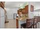 Functional kitchen design with granite countertops, tile backsplash, breakfast bar, and ample cabinet space at 9951 Se 175Th St, Summerfield, FL 34491