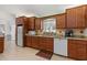 Bright kitchen with wood cabinetry, granite counters, stainless steel sink, and modern appliances at 9951 Se 175Th St, Summerfield, FL 34491