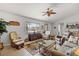 Bright living room featuring neutral colors, comfortable seating, tile flooring, and large windows at 9951 Se 175Th St, Summerfield, FL 34491