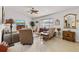 Cozy living room featuring tile flooring, a ceiling fan, and comfortable seating arrangements at 9951 Se 175Th St, Summerfield, FL 34491