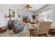 Spacious living room featuring neutral colors, comfortable seating, tile flooring, and large windows, creating a relaxing atmosphere at 9951 Se 175Th St, Summerfield, FL 34491