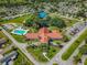 Community aerial view showcasing tennis courts, swimming pool, and large clubhouse at 10347 Se 179Th St, Summerfield, FL 34491