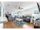 Living room with hardwood floors, ceiling fan, and a pull-out couch at 10347 Se 179Th St, Summerfield, FL 34491