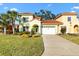 Inviting home with a well-manicured lawn and driveway leading to a two-car garage at 1055 Avenida Sonoma, Lady Lake, FL 32159