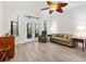 Bright living room featuring tile floors, a decorative fan, and access to the outdoors at 1055 Avenida Sonoma, The Villages, FL 32159