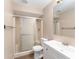 Bathroom with a glass door shower, toilet, and white vanity with a sink at 11032 Moore St, Leesburg, FL 34788