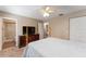 Relaxing bedroom featuring carpet, ceiling fan, dresser and connecting bathroom at 11032 Moore St, Leesburg, FL 34788