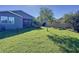 Manicured backyard featuring lush green grass, trees, and a patio area perfect for outdoor activities at 113 Bayou Bend Rd, Groveland, FL 34736