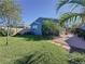 Beautiful backyard featuring lush green grass, a patio, and trees offering plenty of shade at 113 Bayou Bend Rd, Groveland, FL 34736