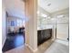 Bathroom view to bedroom, showcasing double vanity, walk-in shower, and modern finishes at 113 Bayou Bend Rd, Groveland, FL 34736