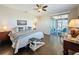 Well-lit bedroom with access to a screened patio, hardwood floors, and ceiling fan at 113 Bayou Bend Rd, Groveland, FL 34736