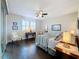 Cozy bedroom with hardwood floors, natural light, and comfortable decor at 113 Bayou Bend Rd, Groveland, FL 34736