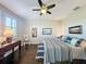 Comfortable bedroom with a ceiling fan, hardwood floors, and sunny window at 113 Bayou Bend Rd, Groveland, FL 34736