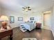 Inviting bedroom featuring hardwood floors, a ceiling fan, and natural light at 113 Bayou Bend Rd, Groveland, FL 34736