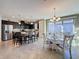 Bright dining area with a modern chandelier, table, and stainless steel appliances at 113 Bayou Bend Rd, Groveland, FL 34736