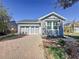 Charming single-Gathering home featuring a two-car garage and a brick driveway at 113 Bayou Bend Rd, Groveland, FL 34736