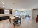 Open-concept kitchen with island seating flowing into dining and living areas at 113 Bayou Bend Rd, Groveland, FL 34736