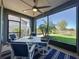 Covered lanai has a ceiling fan and an outside dining table for outdoor entertaining at 113 Bayou Bend Rd, Groveland, FL 34736